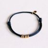 Satijn armbandje met ringen - zwart/goud